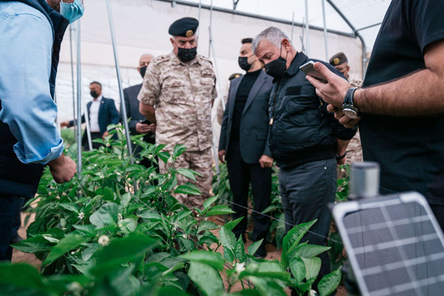 His Majesty King Abdullah visits an agricultural mega-project implemented by the Jordan Armed Forces-Arab Army in Al Ghamr on Tuesday (Photo courtesy of Royal Court)